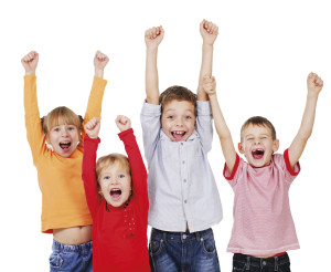 Happy kids with their hands up isolated on white